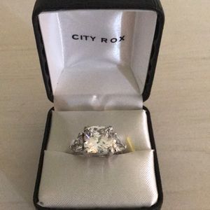 Silver colored ring with huge clear stone.